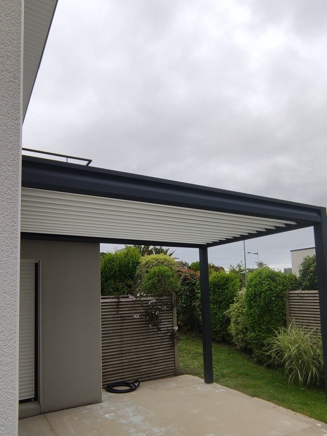 Pergola bioclimatique anthracite sur dalle béton à Guidel